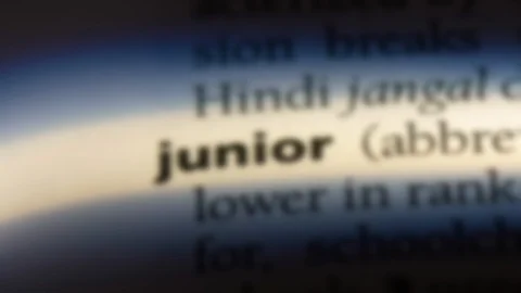 Junior word in a dictionary. Stock Footage 99561828