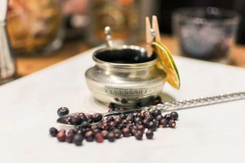 Juniper Berries on a silver spoon Stock Photos