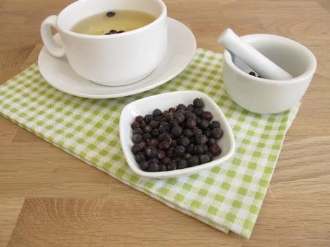Juniper berries tea and dried juniper berries Stock Photos