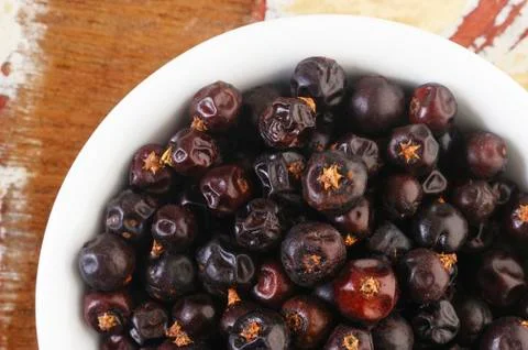 Juniper berries in white dish Stock Photos