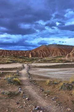 Juniper Draw Trail and Dramatic Eroded Formations Under Stormy Sky Stock Photos