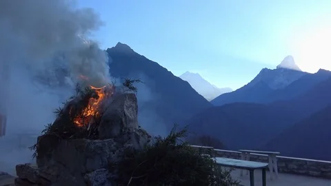 Juniper incense burning on stone altar and mount Ama Dablam at sunrise Stock Footage 78524142