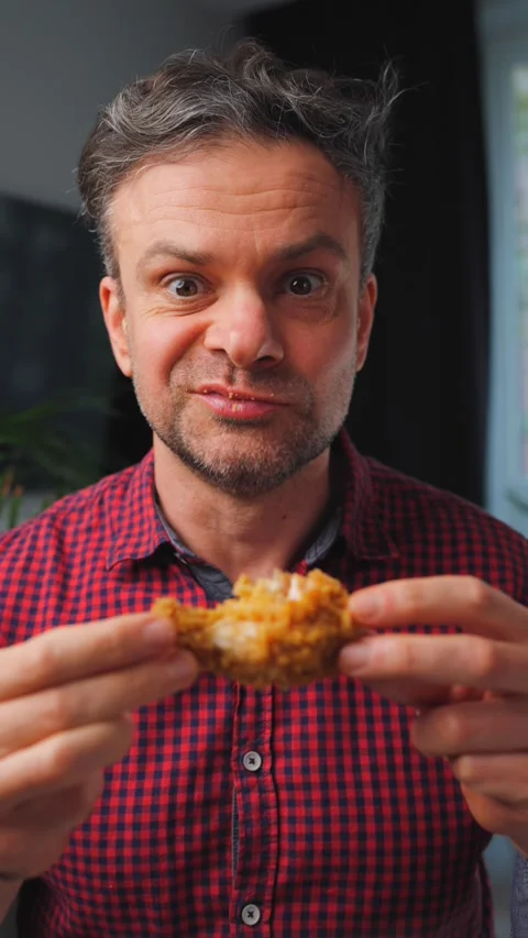 Junk food advertisement concept. Man eating fried chicken, enjoying fast food. Video stock 342811160