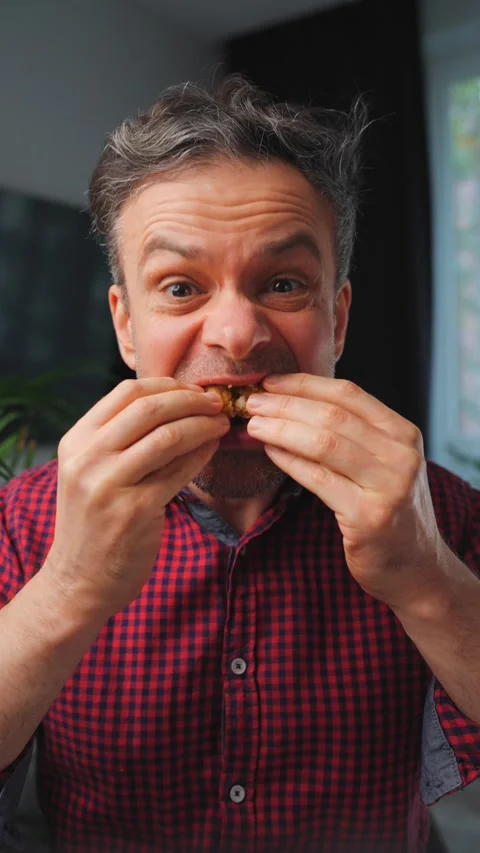Junk food advertisement concept. Man eating fried chicken, enjoying fast food. Stock Footage 342832979