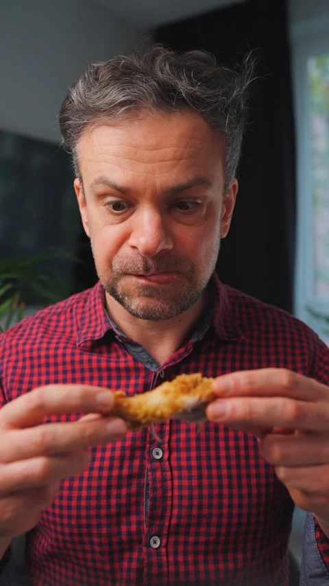 Junk food advertisement concept. Man eating fried chicken, enjoying fast food. Stock Footage 346728660