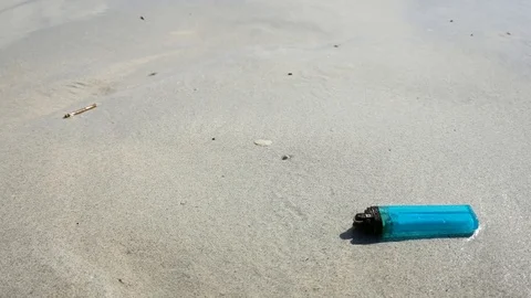 Junk waste lighter on the beach. Stock Footage 90276803