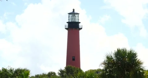Jupiter inlet lighthouse in Jupiter Florida cloudy blue sky red lighthouse Stock Footage 213388711