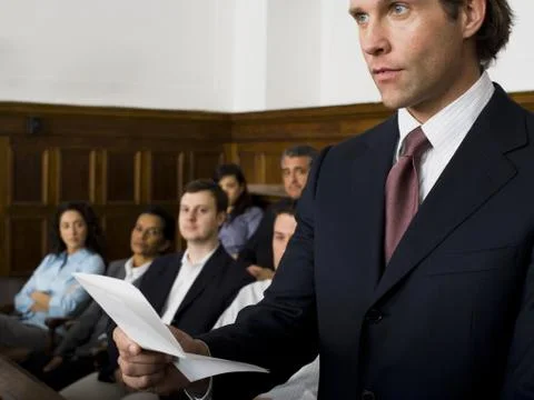 Juror standing in a jury box and reading the verdict Stock Photos