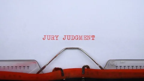 Jury judgemnt - phrase printed on an old typewriter in red letters, close up. Stock-Footage 128400272