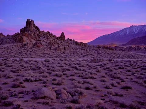 Just after sunset, Alabama Hills, dirt road winds through the valley. Stock Photos