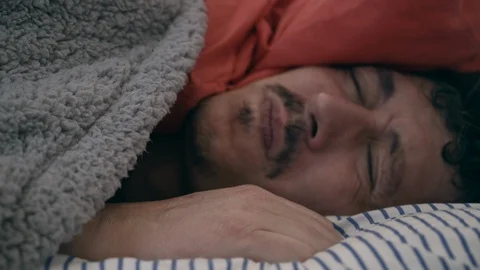 Just awake sleepyhead man does not want to get out of bed Stock Footage 128989585