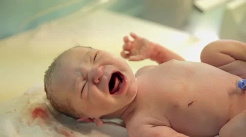 Just-born baby is crying on a table Stock Footage 40020471