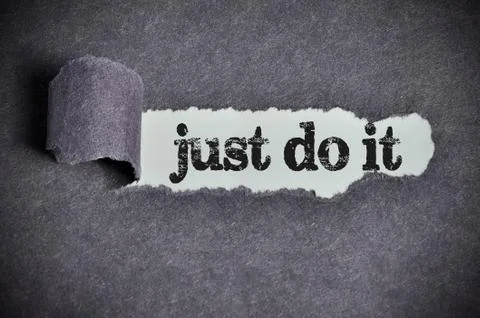 Just do it  word under torn black sugar paper Foto stock