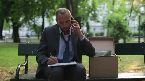 Just fired, unemployed businessman looking for job in newspaper HD Stock Footage