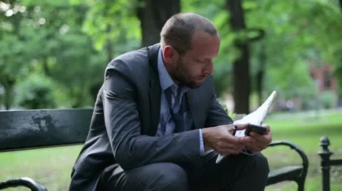 Just fired, unemployed businessman looking for job in newspaper Stock Footage