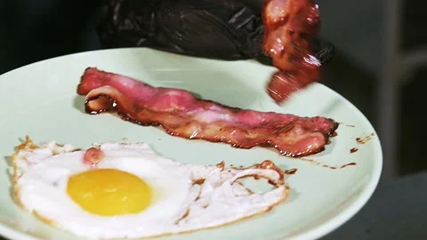 Just fried bacon and red onion rings on a plate Stock Footage 101750603