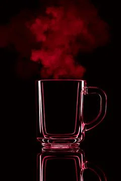 Just a glass on a black background with a reflection. Red color, with steam. Stock Photos