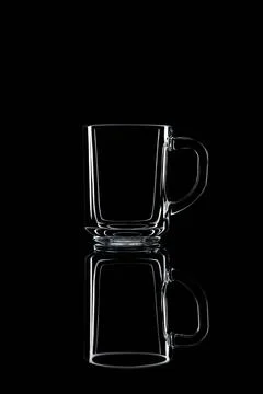 Just a glass on a black background with a reflection. Stock Photos