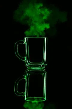 Just a glass on a black background with a reflection. Green color, with steam Stock Photos