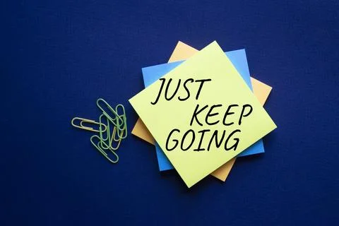 Just keep going symbol. Yellow steaky note with words Just keep going. Beau.. Stock Photos