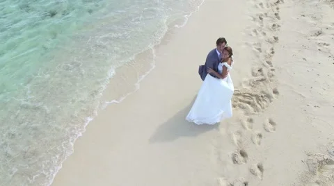 Just-married couple on a caribbean beach, wedding day - drone view Stock-Footage 59222079