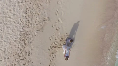 Just-married couple on a caribbean beach, wedding day - drone view Stock-Footage 59222759