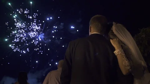 Just married couple is looking at fireworks in the night sky Video stock 101570862