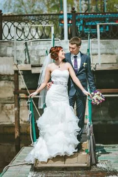 Just married couple posing in small cove. Happy bride and groom on their wedding Stock Photos
