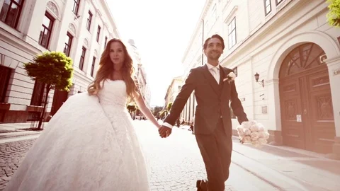 Just Married Couple Walking Down The Street on Wedding Sunny Day Slow Motion Stock Footage 71424236