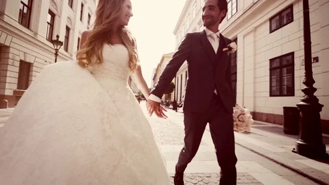 Just Married Couple Walking Down The Street on Wedding Sunny Day Slow Motion Stock Footage