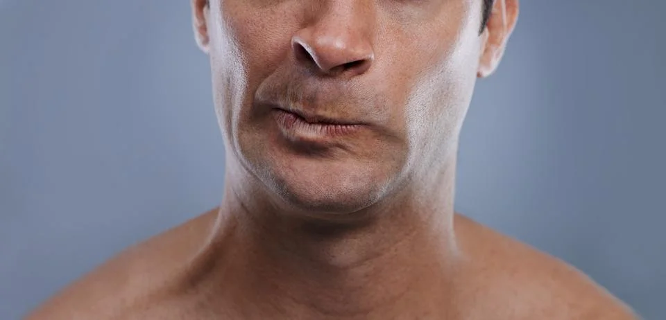 Just not close enough...Cropped studio shot o0f the lower half of a young mans Stock Photos