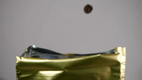 Just roasted coffee beans are poured down to the packaging in slow motion Stock Footage 113594970