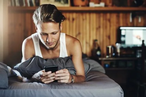 Just sorting out my plans for the weekend. a handsome young man using his Stock Photos