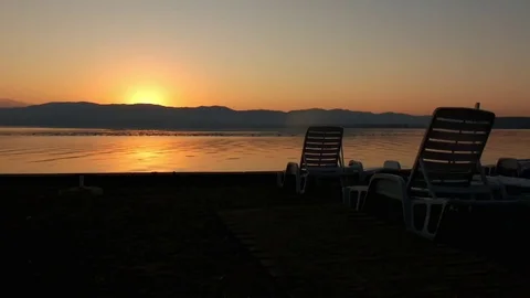 Just before sun rising behind mountain and an empty beach Stock Footage 78163693