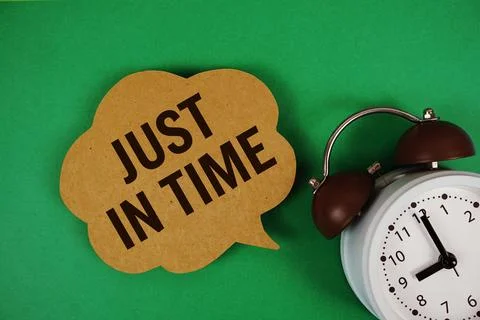 Just In Time text on speech bubble with alarm clock on green background 写真素材