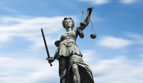 Justitia on blue sky 스톡 사진