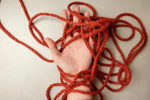 Jute rope patterns entwining hands in Japanese bondage art Stock Photos