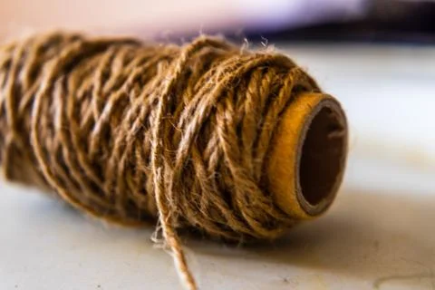 Jute string roll close up on blurred white background Stock Photos