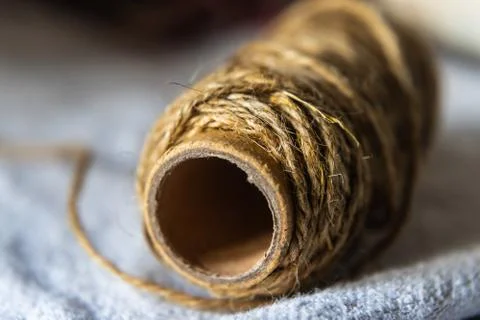Jute string roll close up on linen fabric background Stock Photos