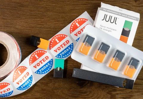 Juul Labs vaping e-cigarette with I voted sticker to illustrate political issues Stock Photos