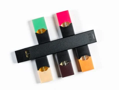 JUULpods and dispenser containing different flavors of nicotine Stock Photos