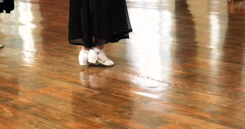 Juvenile-class dancers practicing Standard-style dance moves on the floor Stock Footage 346384262