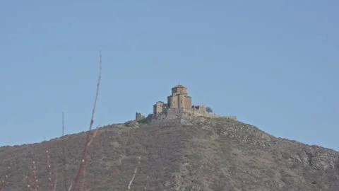 Jvari Monastery on Hilltop Under Clear Blue Sky Vidéo 335107644
