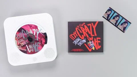 K-pop group Itzy CRAZY IN LOVE 1st Album photobook with photo card on grey. P Stock Photos