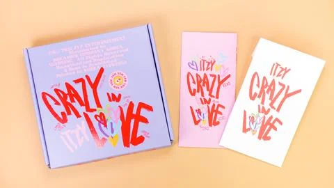 K-pop group Itzy CRAZY IN LOVE 1st Album on yellow background. Special edit.. Stock Photos
