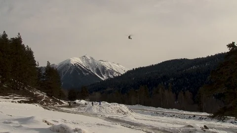Ka-32 in flight with bunker on background of snow-capped peaks. Stock Footage 106857254