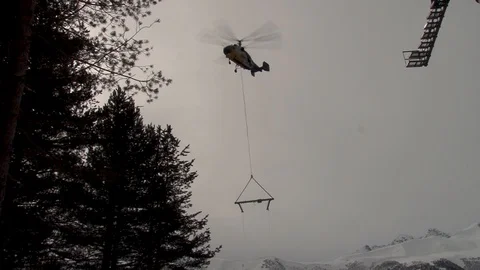 Ka-32 helicopter flies up to support of cable car multi-ton metal structure Stock Footage 106491459