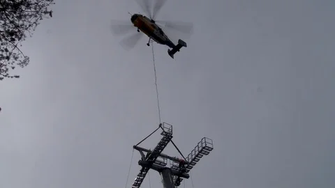 Ka-32 helicopter holdsa multi-ton metal structure in hovering mode. Stock Footage 106607398