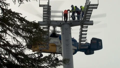 Ka-32 helicopter in hovering mode few meters from support of cable car. Stock Footage 106370158