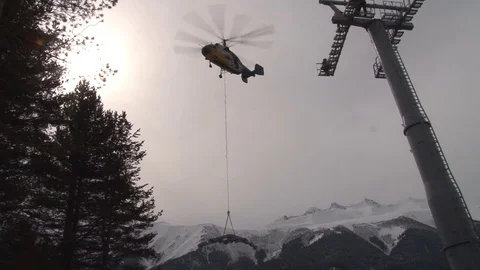 Ka-32 helicopter at installation of cableway in hang mode with cargo. Stock Footage 106771854